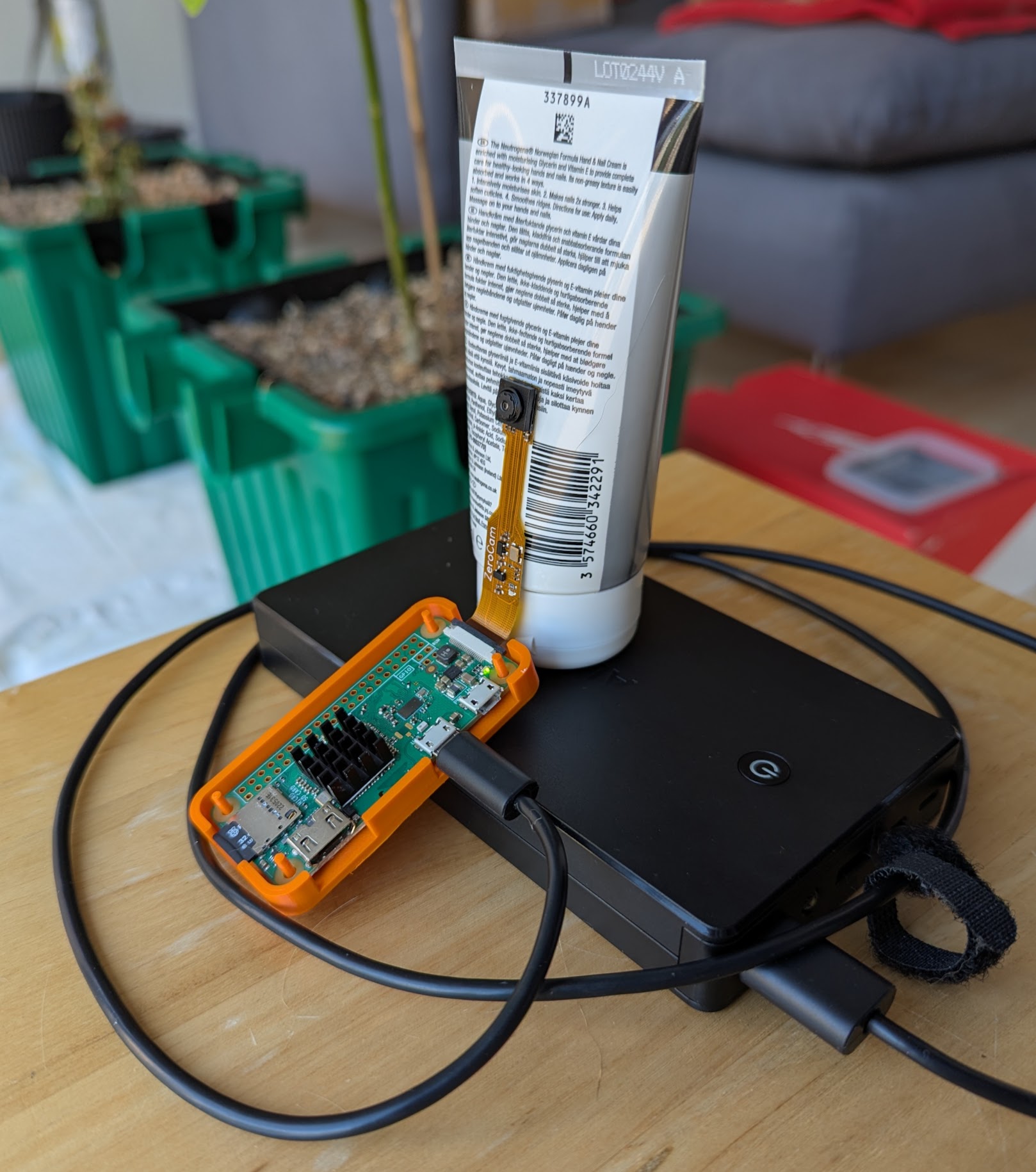 The original Pi Zero W and Zero Cam powered by USB battery pack supported by some hand cream