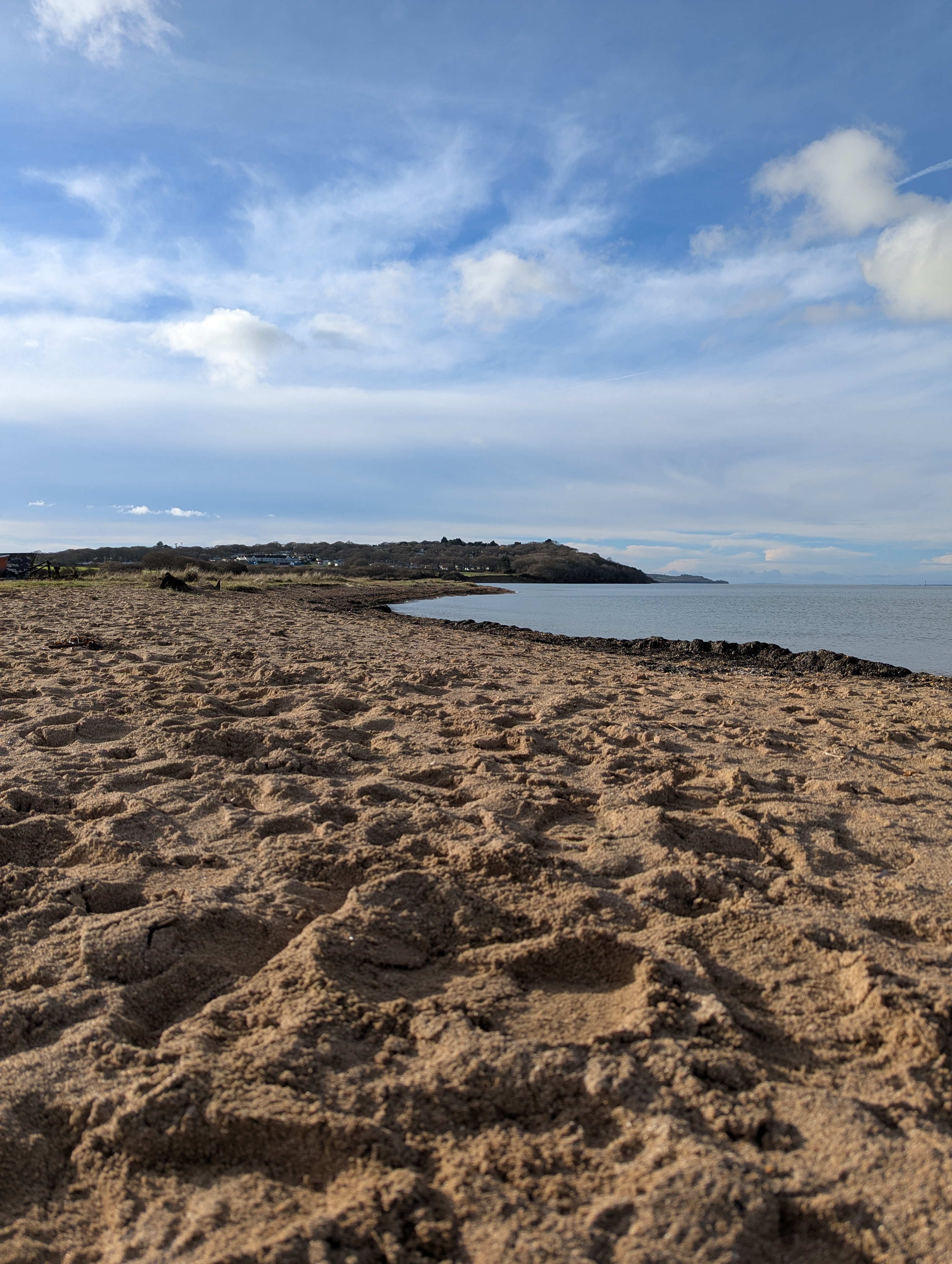 View of a sunny Thorness Bay with a sandy beach.
